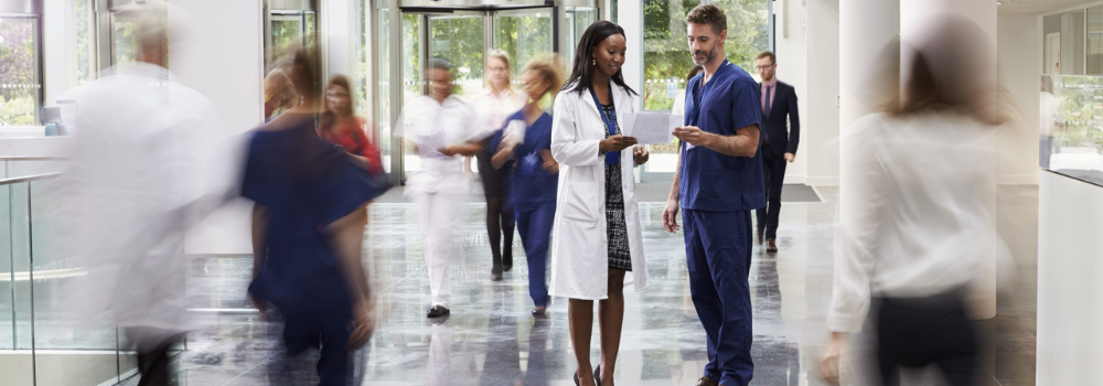 Busy hospital setting with healthcare professionals in motion, representing the demand for Allied Health Professionals (AHPs). Hunter Gatherer AHP connects skilled locum and permanent AHPs with NHS and private sector roles across the UK.