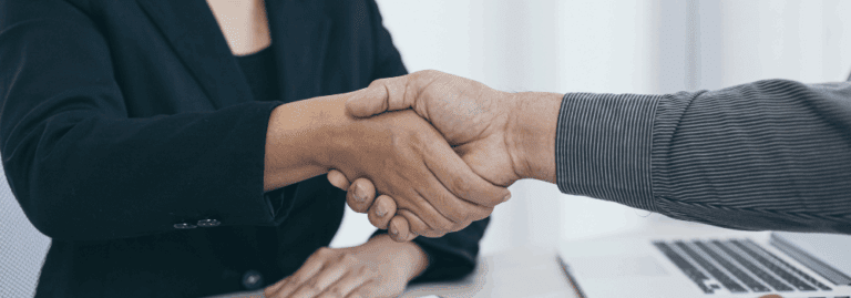 A professional handshake between two individuals, representing the collaboration and skills employers seek in AHP candidates in 2025. Learn more in our latest blog at Hunter Gatherer AHP.