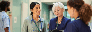 Healthcare professionals and recruitment consultant discussing staffing solutions in a hospital setting