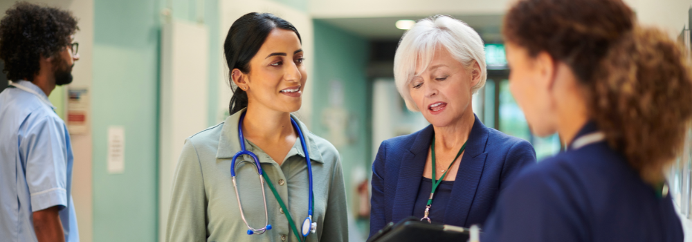 Healthcare professionals and recruitment consultant discussing staffing solutions in a hospital setting