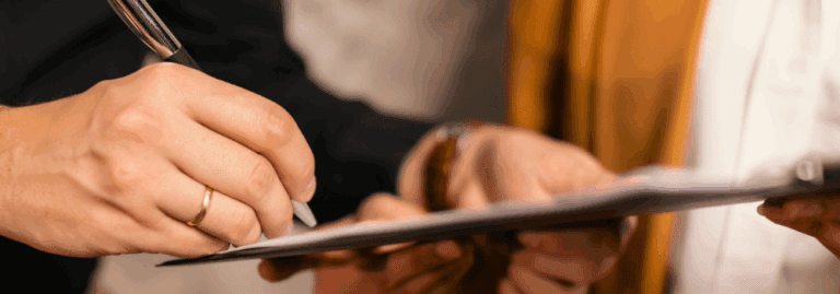 Close-up of a compliance professional at Hunter Gatherer AHP completing documentation and verifying credentials as part of the AHP recruitment process.