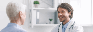 Primary Care locum doctor smiling with a patient during consultation