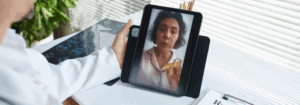 Doctor providing an online consultation with a patient via tablet