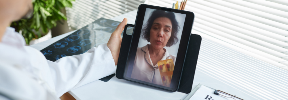 Doctor providing an online consultation with a patient via tablet