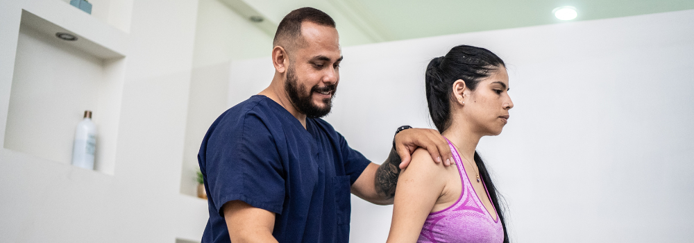 Physiotherapist supporting a patient during a rehabilitation session