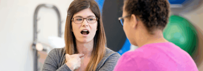 Speech and Language Therapist working with an adult patient to improve speech and communication skills in a clinical setting